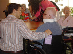 Photo of student talking to elderly man