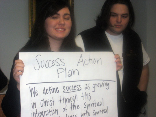 Students holding up Poster